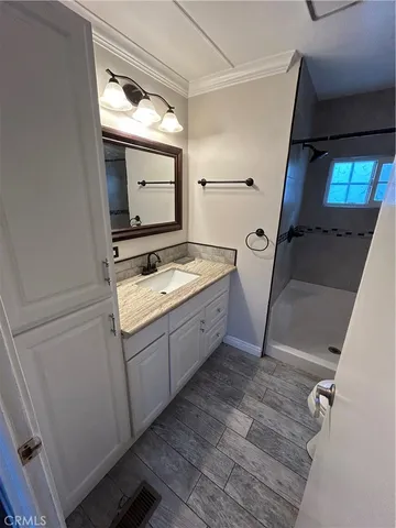 a bathroom with a sink toilet and shower