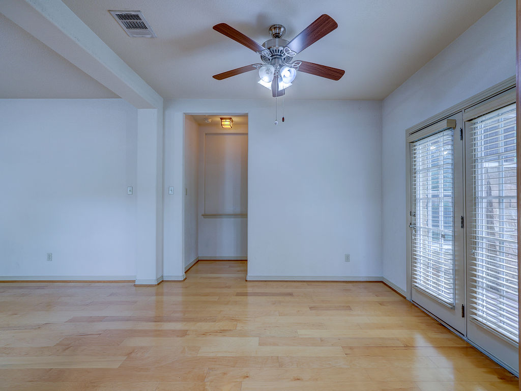 9707 Anderson Mill Road, Unit 22 Austin, TX 78750 - Photo 16 of 39 Blonde hardwood floors grace this living space with direct access to the outdoors.