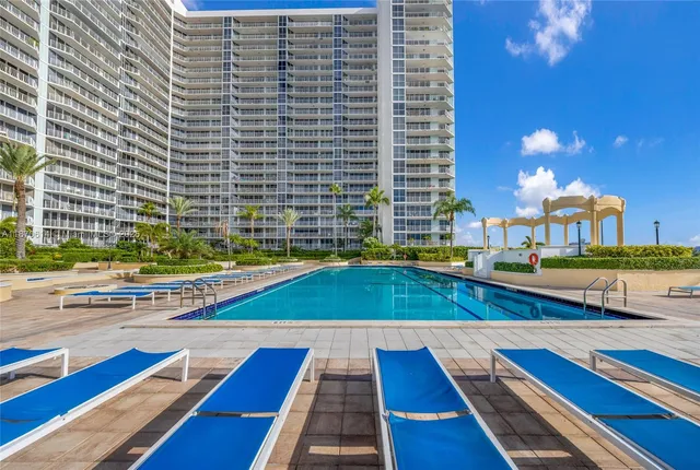 a view of a swimming pool and lounge chairs