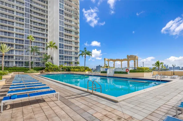a kitchen with stainless steel appliances granite countertop a lot of cabinets and wooden floor
