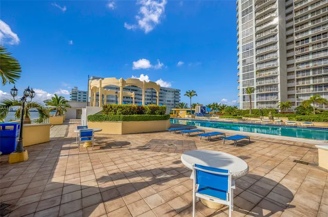 a view of swimming pool with outdoor seating and a patio