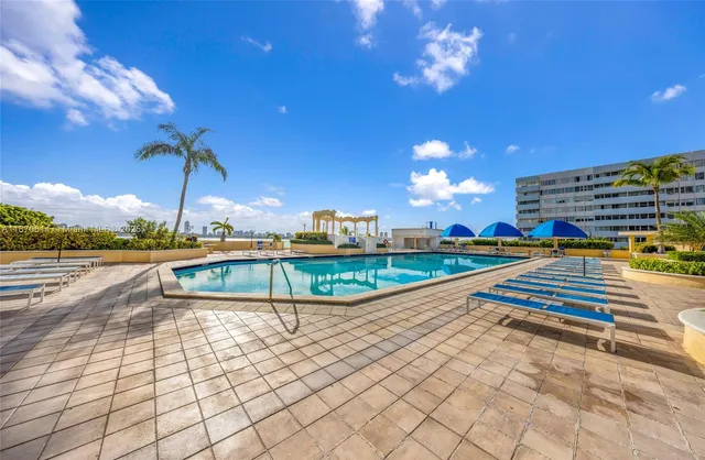 a view of a swimming pool with a lounge chairs