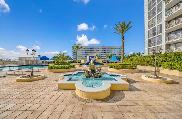 a view of a swimming pool with outdoor seating