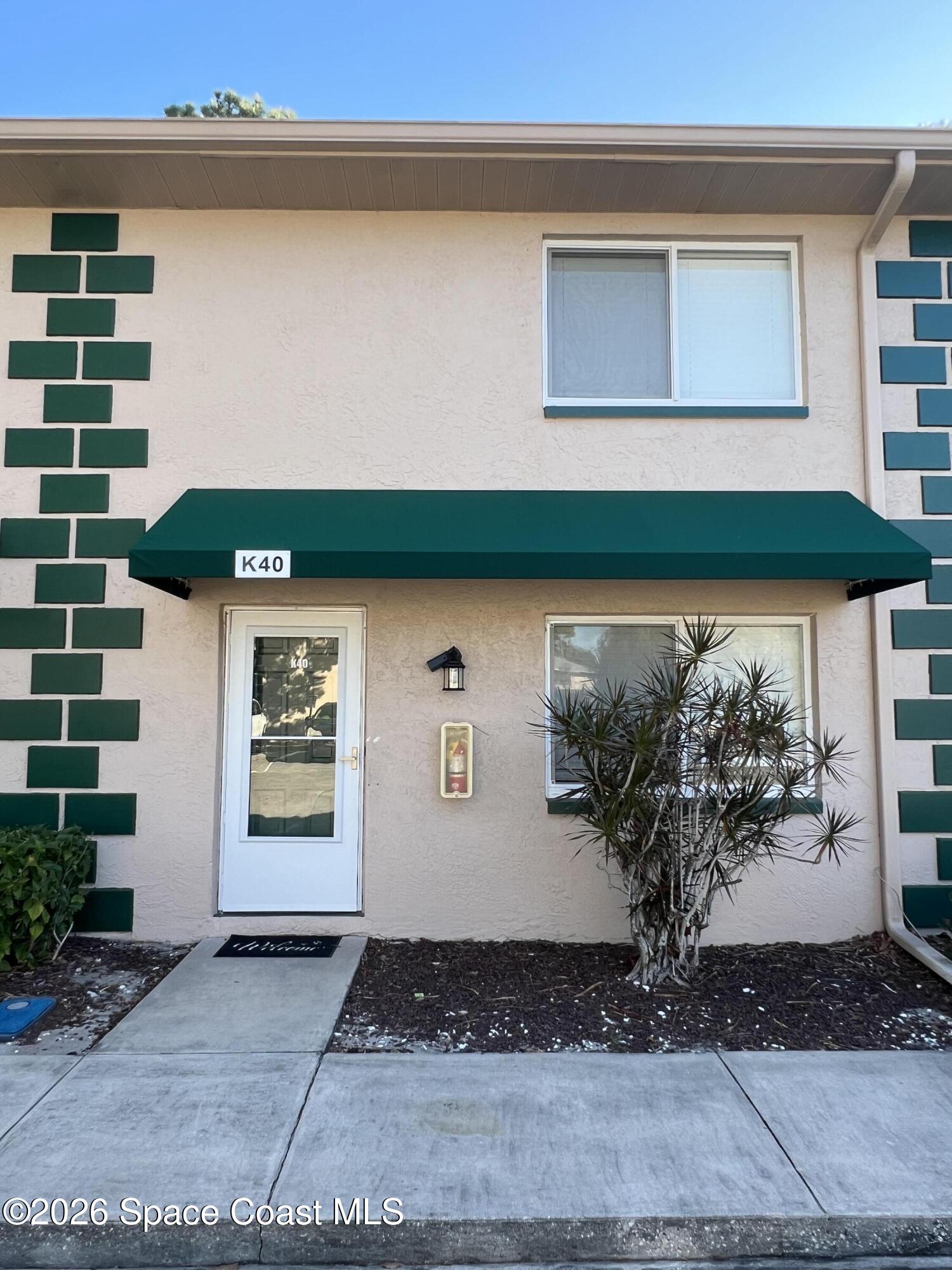 a view of front door and potted plants