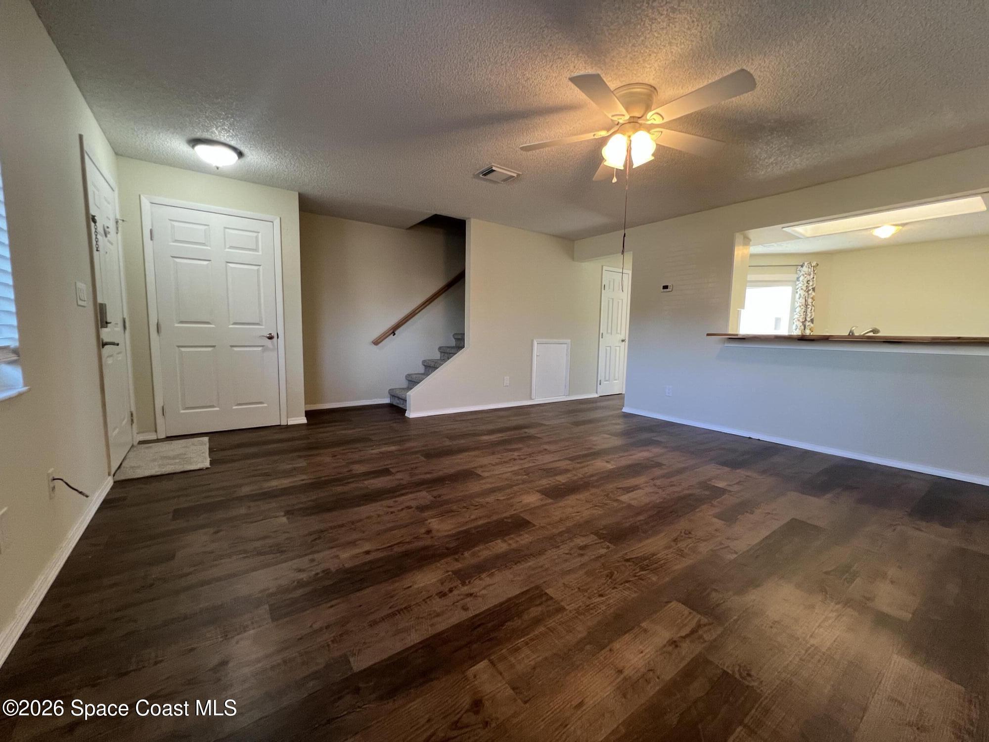 1882 Murrell Road, Unit K40 Rockledge, FL 32955 - Photo 2 of 13 a view of an empty room with window and wooden floor