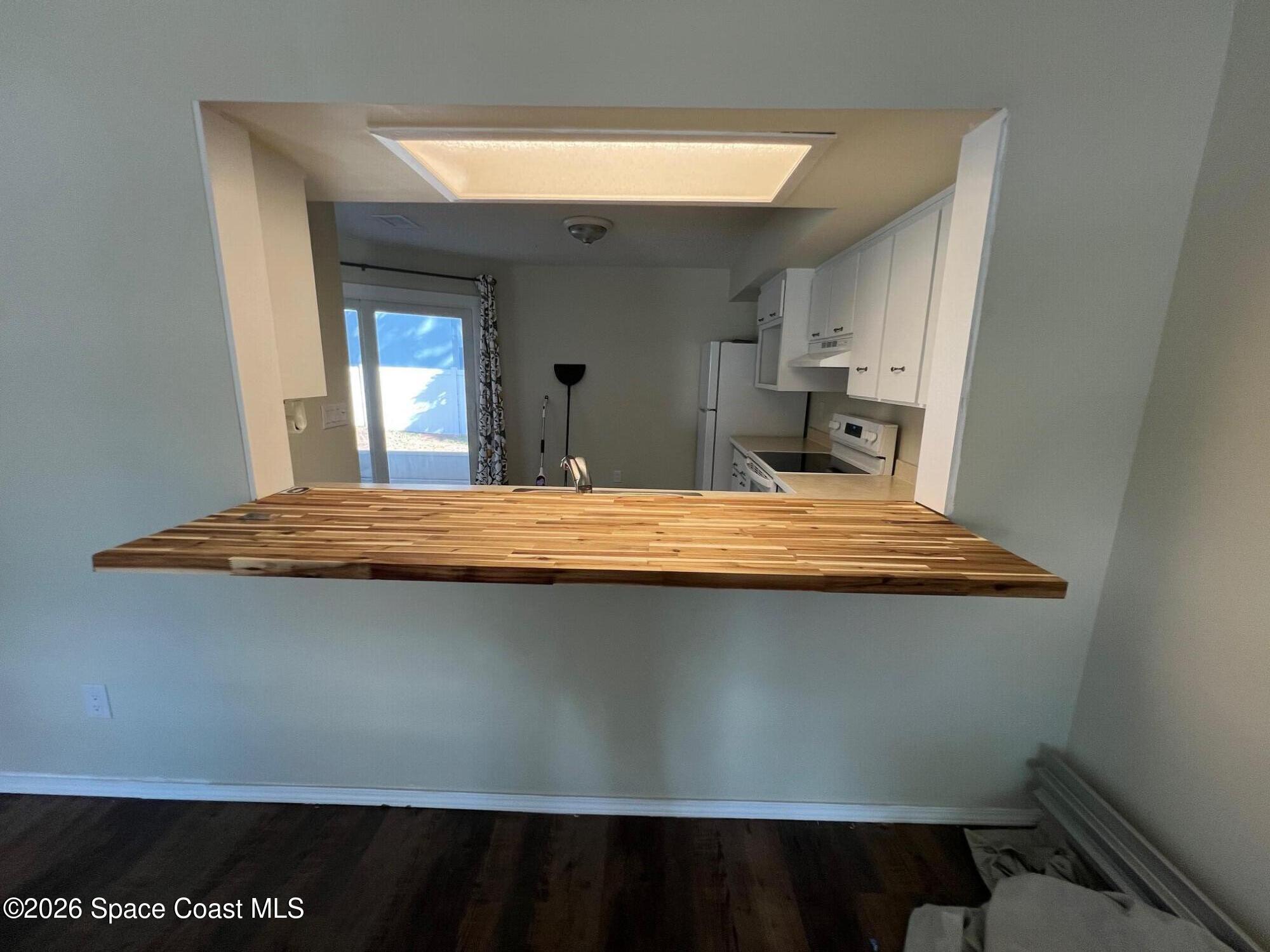 1882 Murrell Road, Unit K40 Rockledge, FL 32955 - Photo 5 of 13 a view of kitchen with kitchen island and wooden floor