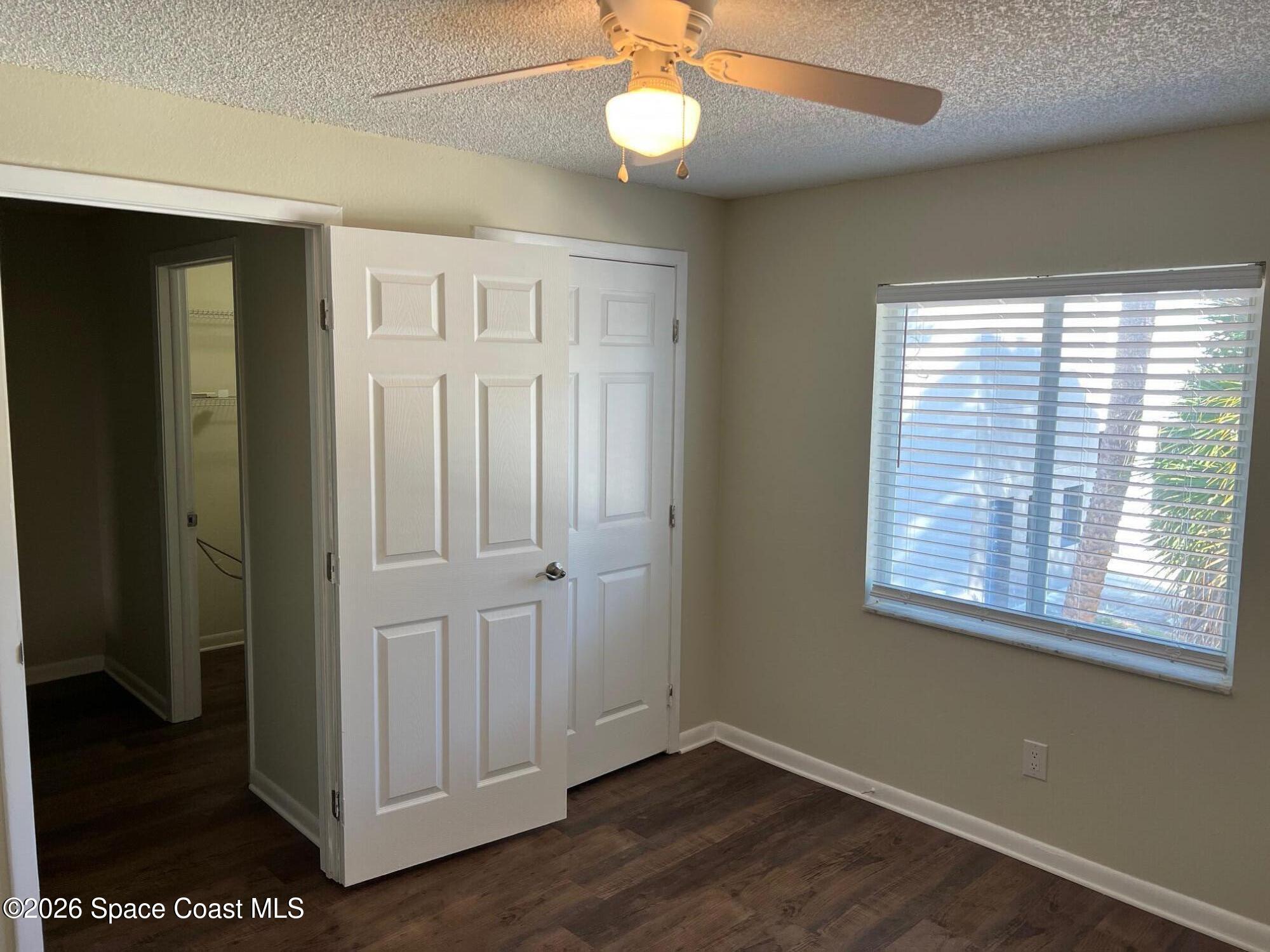 1882 Murrell Road, Unit K40 Rockledge, FL 32955 - Photo 6 of 13 a view of an empty room with wooden floor and a window