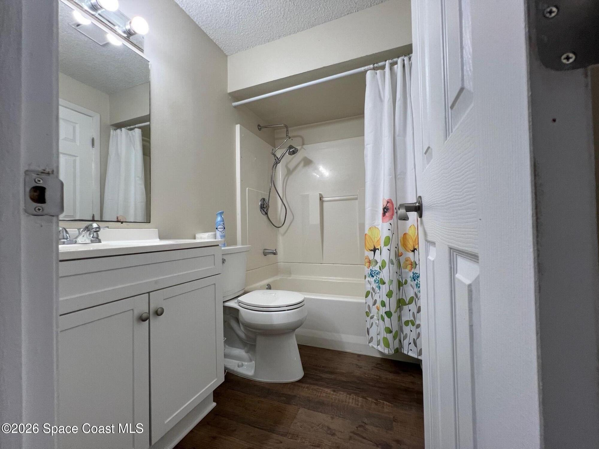 1882 Murrell Road, Unit K40 Rockledge, FL 32955 - Photo 8 of 13 a bathroom with a toilet sink a mirror a vanity and shower