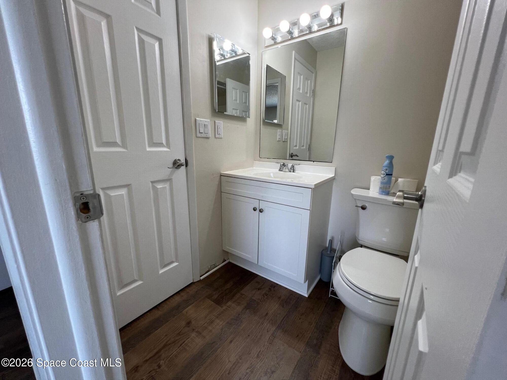 1882 Murrell Road, Unit K40 Rockledge, FL 32955 - Photo 9 of 13 a bathroom with a toilet sink and a mirror