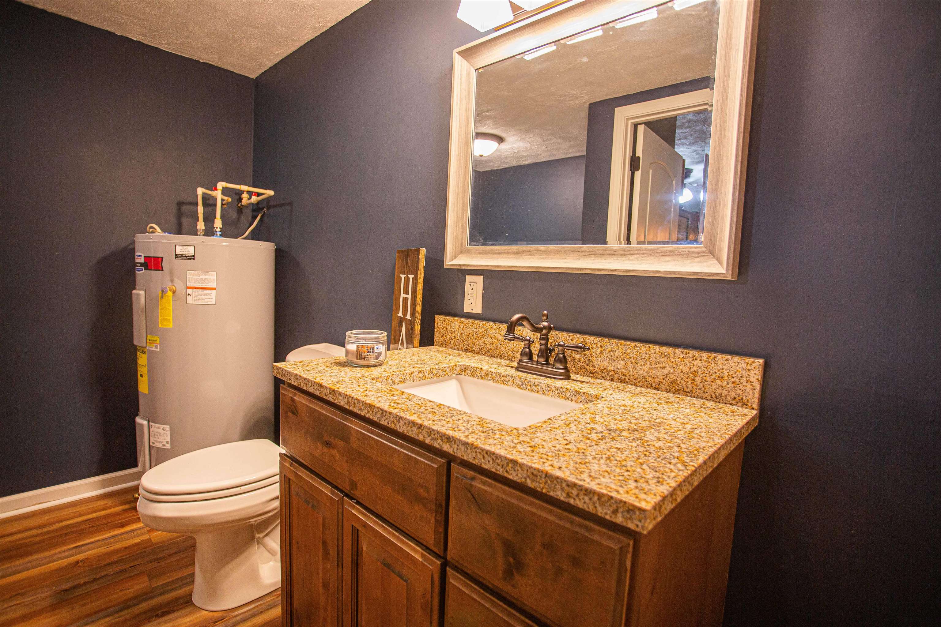 2745 Dry Hill Road West Ripley, TN 38063 - Photo 13 of 23 a bathroom with a granite countertop toilet sink and mirror