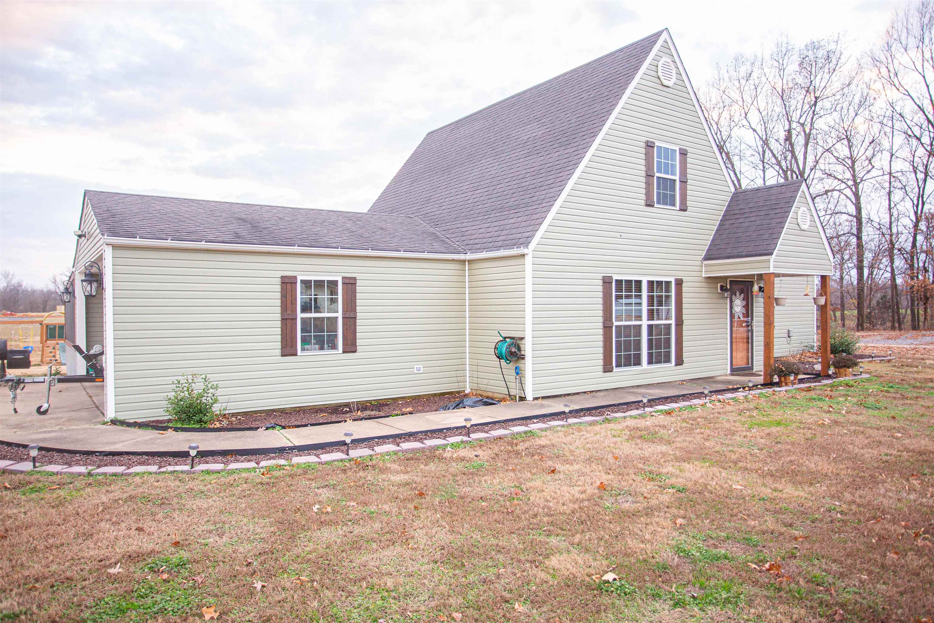 2745 Dry Hill Road West Ripley, TN 38063 - Photo 18 of 23 a front view of a house with a yard and garage