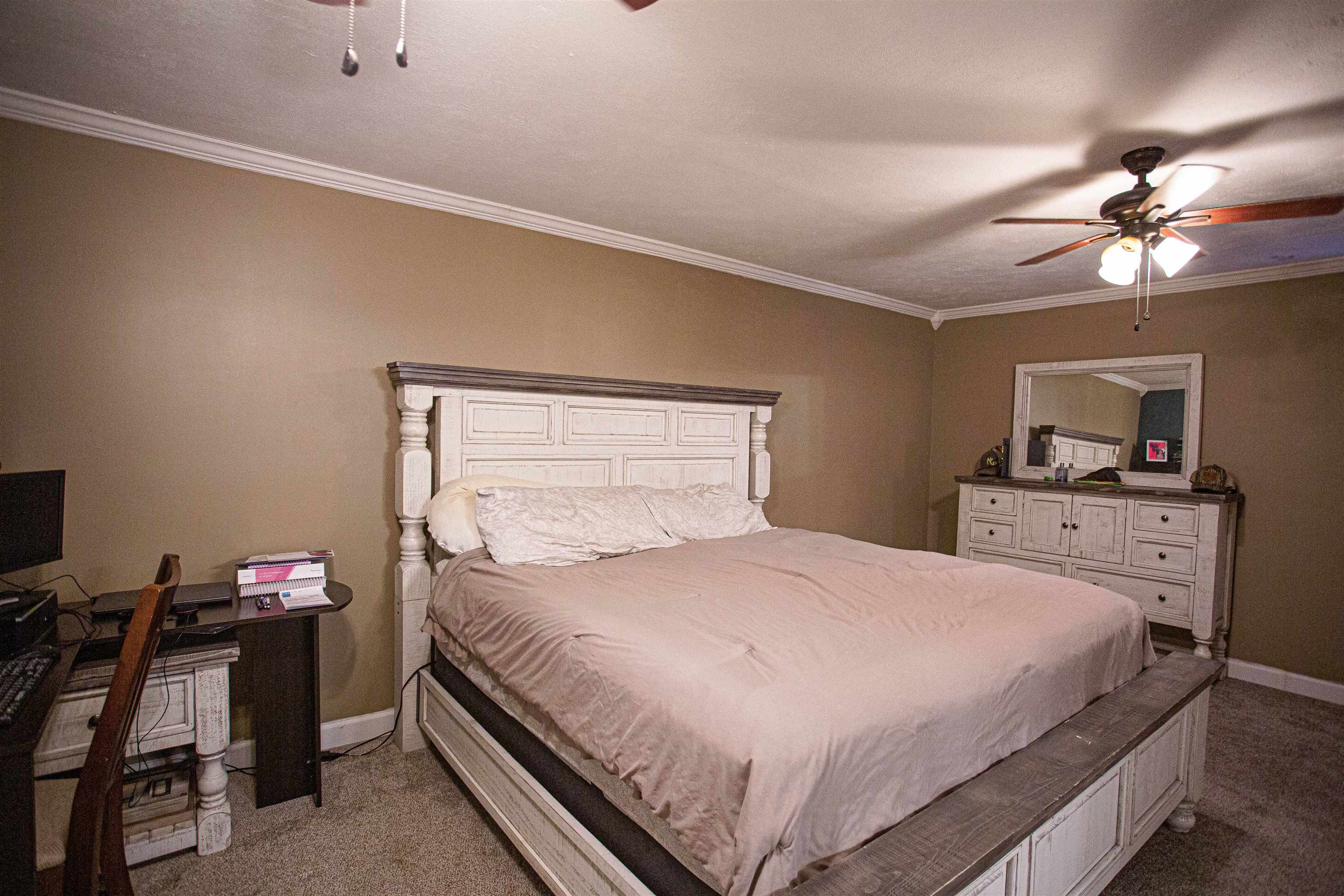 2745 Dry Hill Road West Ripley, TN 38063 - Photo 8 of 23 a bedroom with a bed and a chandelier