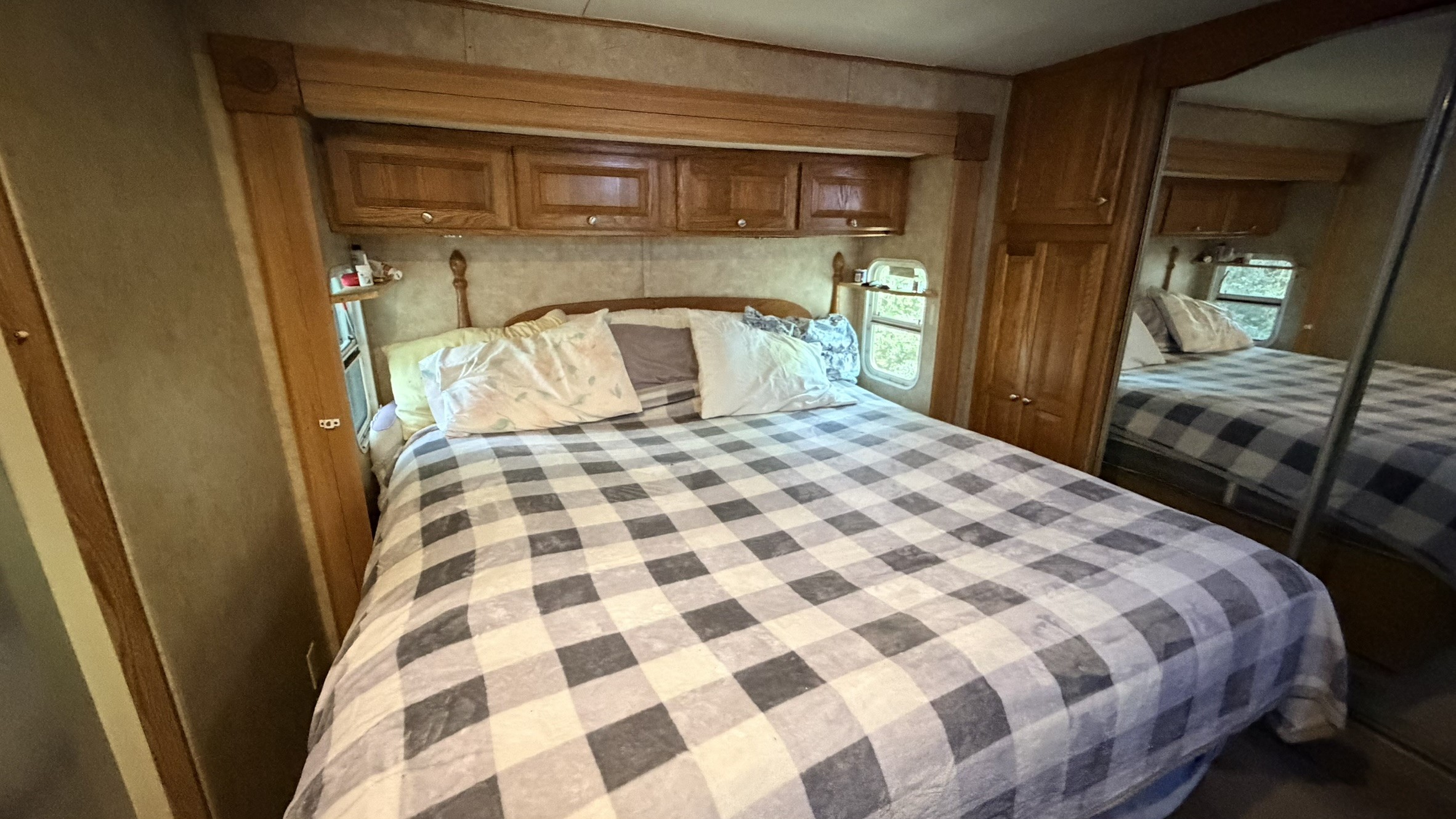 361 Medina Drive Trinity, TX 75862 - Photo 29 of 46 a bedroom with a large bed and a mirror on dresser