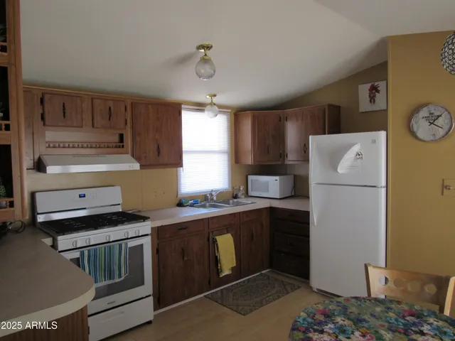 a kitchen with a refrigerator and a stove