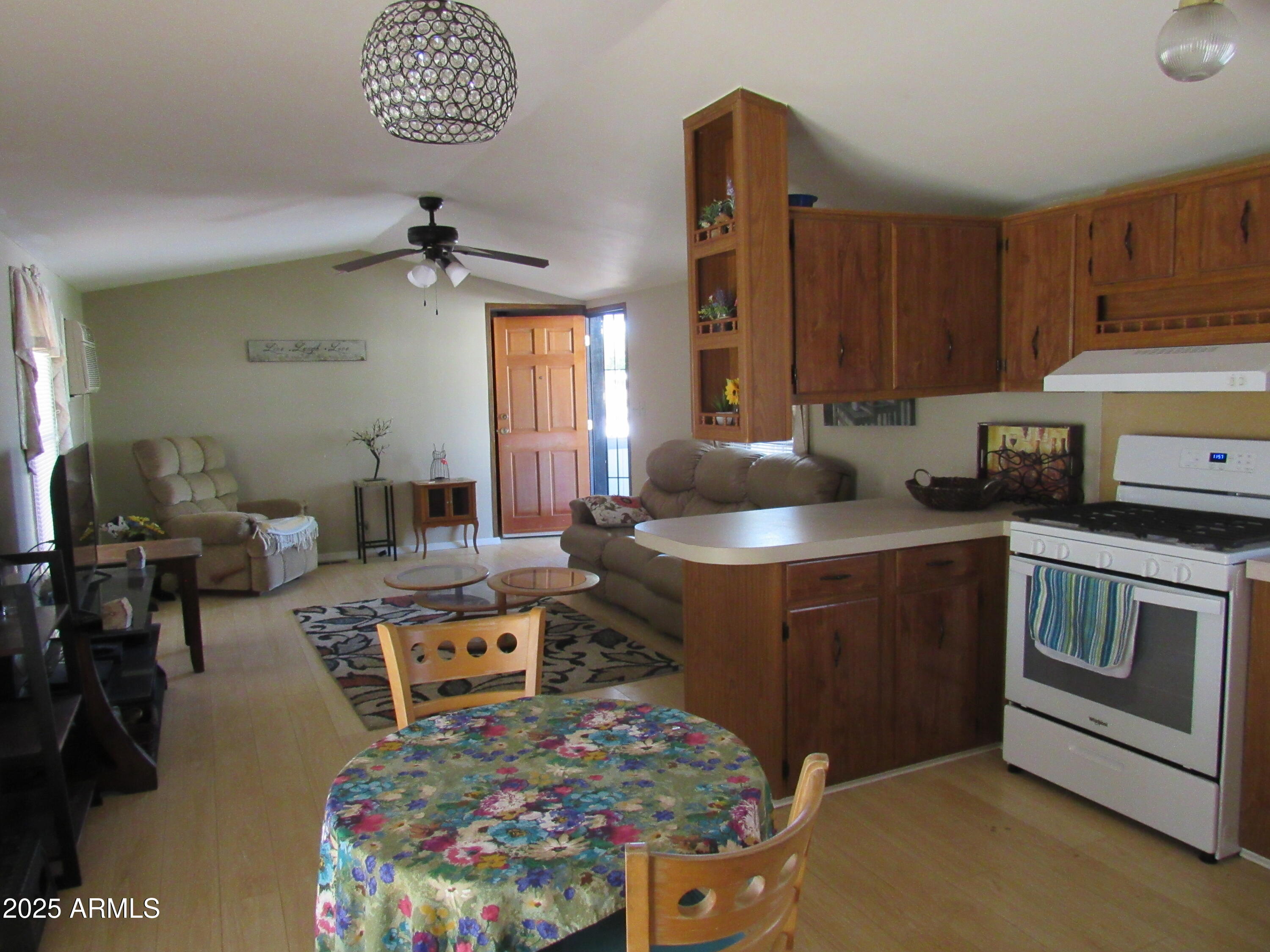 3411 South Camino Seco, Unit 107 Tucson, AZ 85730 - Photo 7 of 15 a kitchen with a stove a sink and a refrigerator