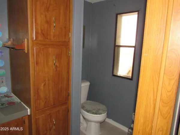 a bathroom with a granite countertop toilet and a sink