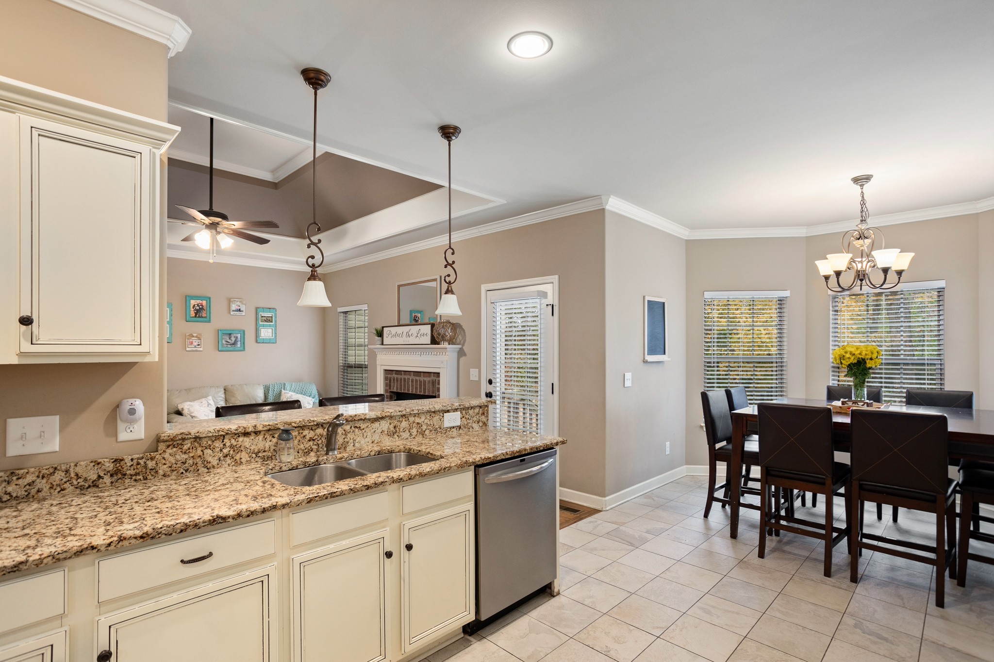 1086 Golf View Way Spring Hill, TN 37174 - Photo 11 of 25 a kitchen with granite countertop a sink dining table and chairs