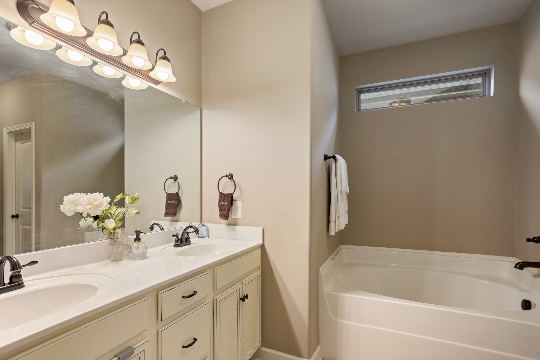 1086 Golf View Way Spring Hill, TN 37174 - Photo 14 of 25 a bathroom with a tub sink and mirror