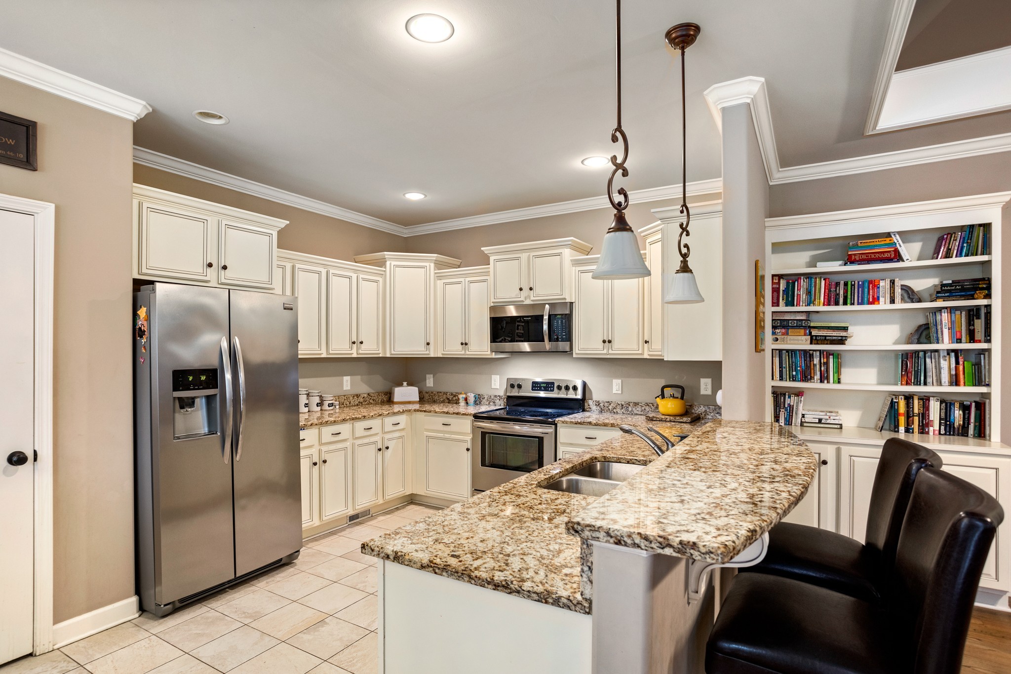 1086 Golf View Way Spring Hill, TN 37174 - Photo 9 of 25 a kitchen with stainless steel appliances granite countertop a sink a stove a refrigerator cabinets and chairs