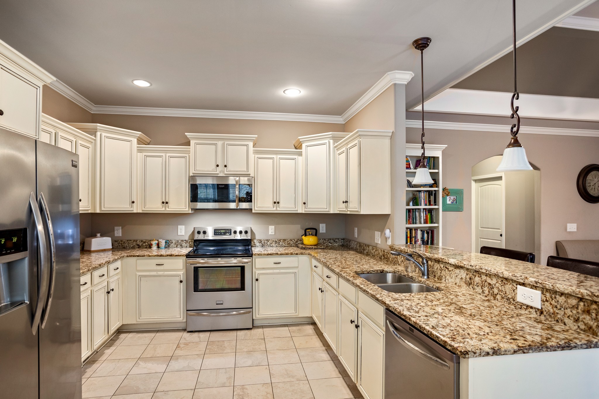 1086 Golf View Way Spring Hill, TN 37174 - Photo 10 of 25 a kitchen with granite countertop a sink stainless steel appliances and cabinets