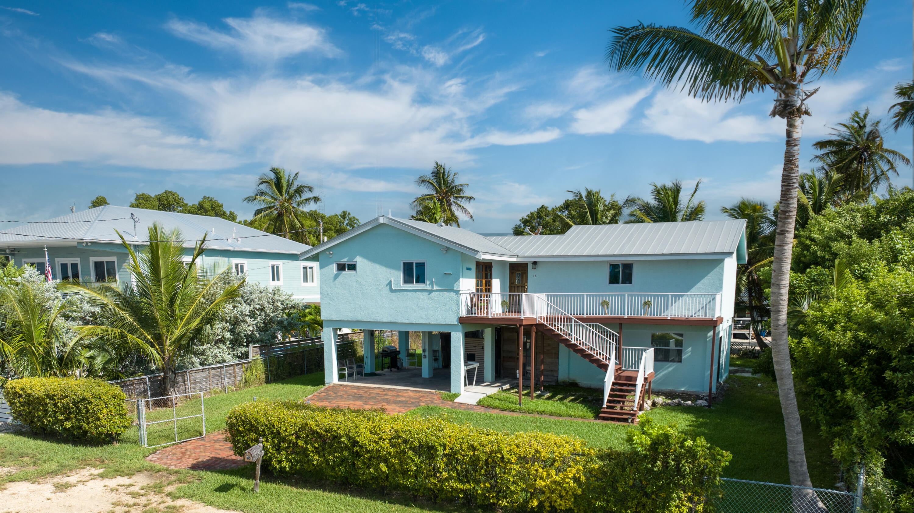 18 North Channel Drive Key Largo, FL 33037 - Photo 1 of 40 a front view of a house with a garden