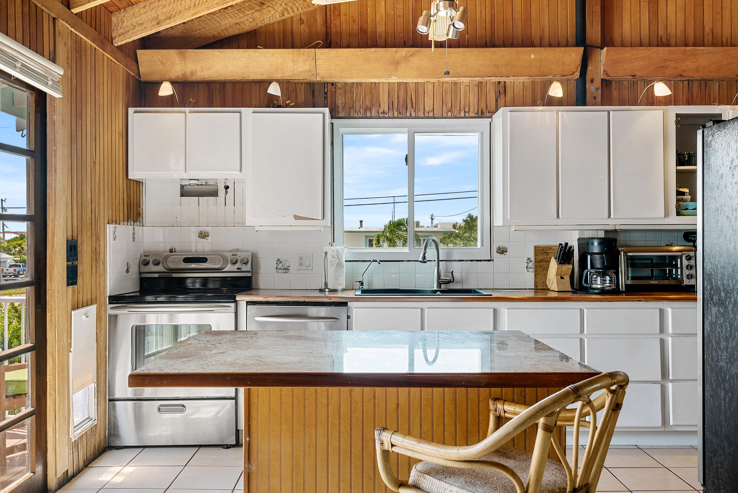 18 North Channel Drive Key Largo, FL 33037 - Photo 9 of 40 a kitchen with stainless steel appliances granite countertop a stove a sink and a microwave