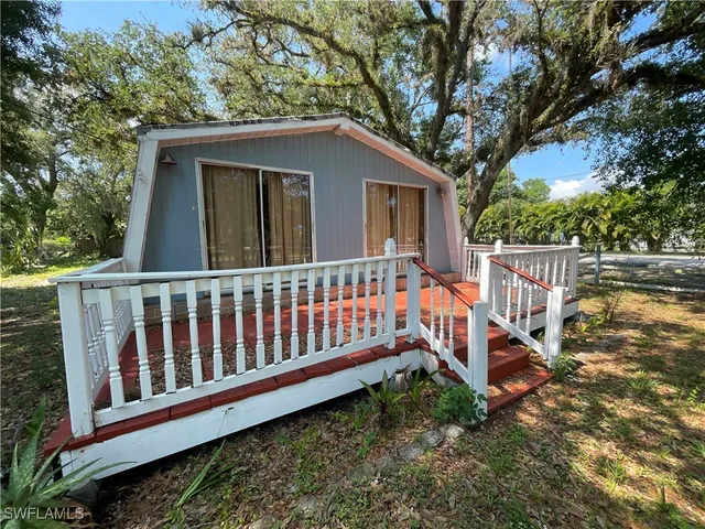 a view of a house with wooden fence