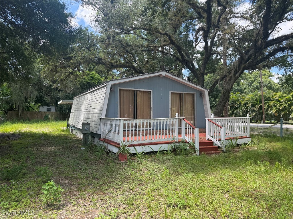 1349 Shawnee Avenue LaBelle, FL 33935 - Photo 3 of 10 a view of a house with a yard and deck