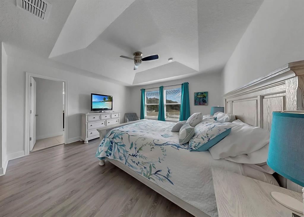 10212 Newel Valley Loop Riverview, FL 33569 - Photo 15 of 72 a bedroom with a large bed and a tv