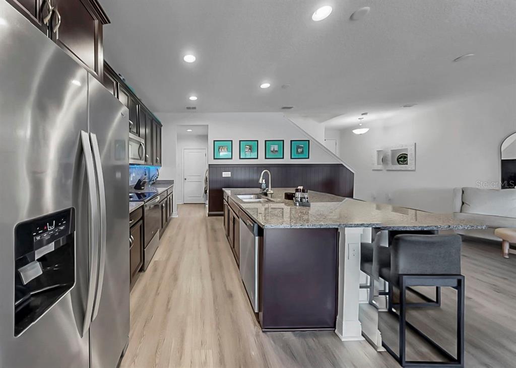 10212 Newel Valley Loop Riverview, FL 33569 - Photo 24 of 72 a kitchen with stainless steel appliances granite countertop a refrigerator a stove and a sink