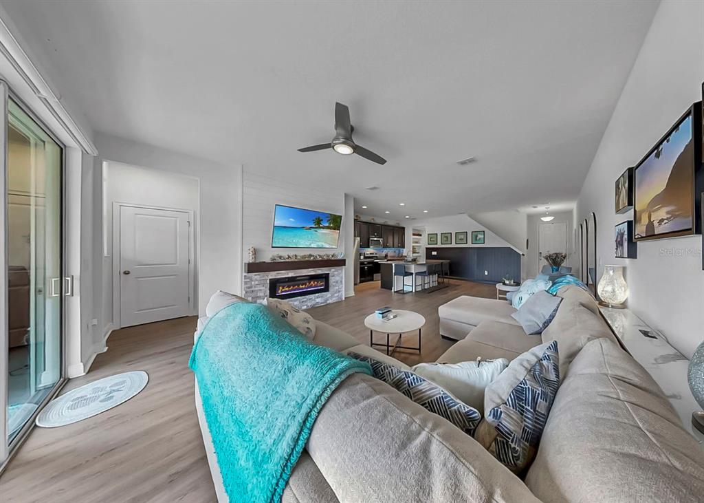 10212 Newel Valley Loop Riverview, FL 33569 - Photo 26 of 72 a living room with furniture a flat screen tv and a fireplace
