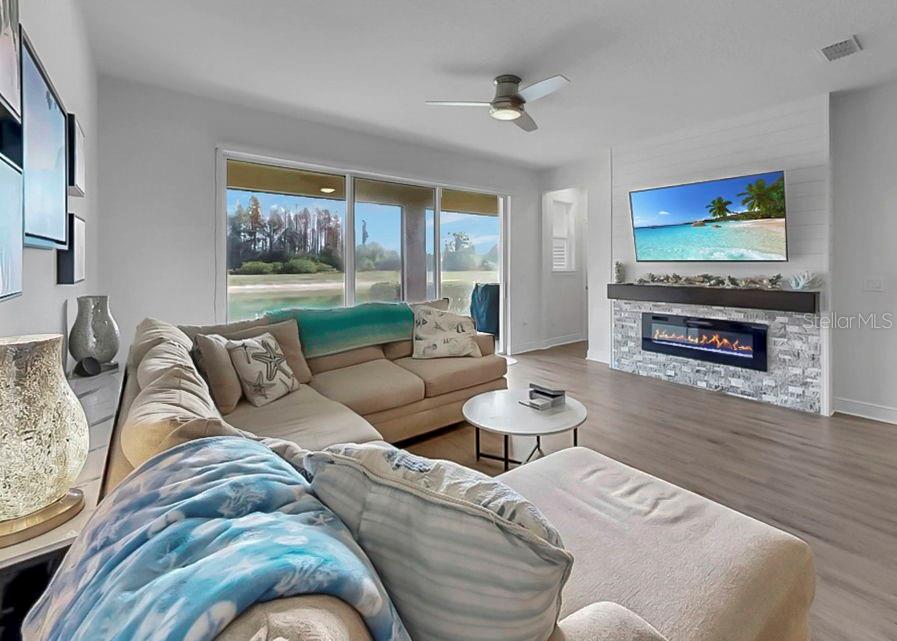 10212 Newel Valley Loop Riverview, FL 33569 - Photo 27 of 72 a living room with furniture a flat screen tv and a fireplace