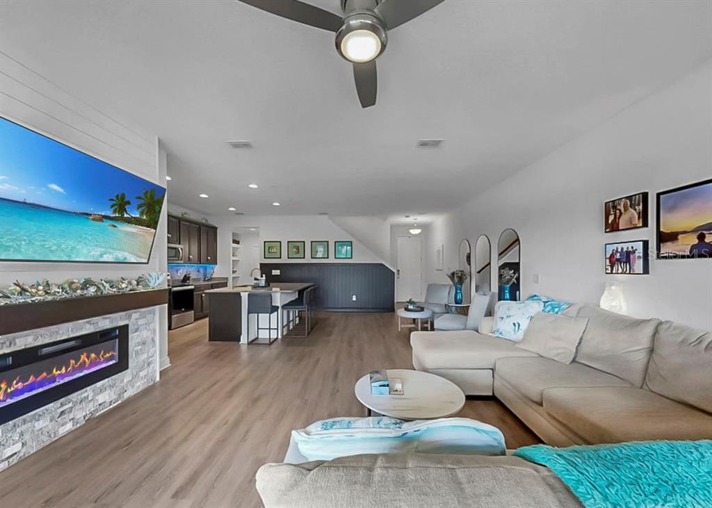 10212 Newel Valley Loop Riverview, FL 33569 - Photo 30 of 72 a living room with furniture a flat screen tv and kitchen view