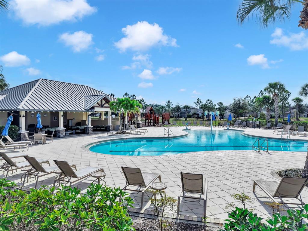 10212 Newel Valley Loop Riverview, FL 33569 - Photo 55 of 72 a view of a patio with table and chairs under an umbrella