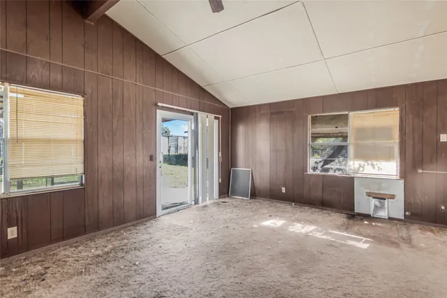 a view of a kitchen with refrigerator and windows