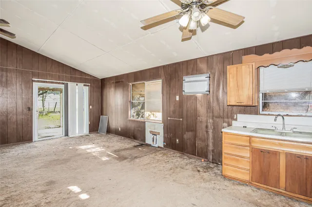 a spacious bathroom with a granite countertop sink a shower and a mirror