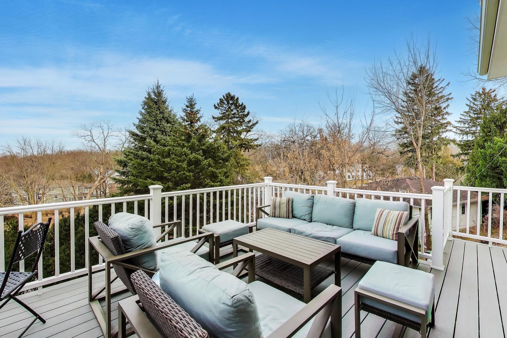 603 Agaming Road Fontana, WI 53125 - Photo 19 of 68 Expansive composite deck surrounded by mature trees, providing a private setting to relax and enjoy the surroundings.