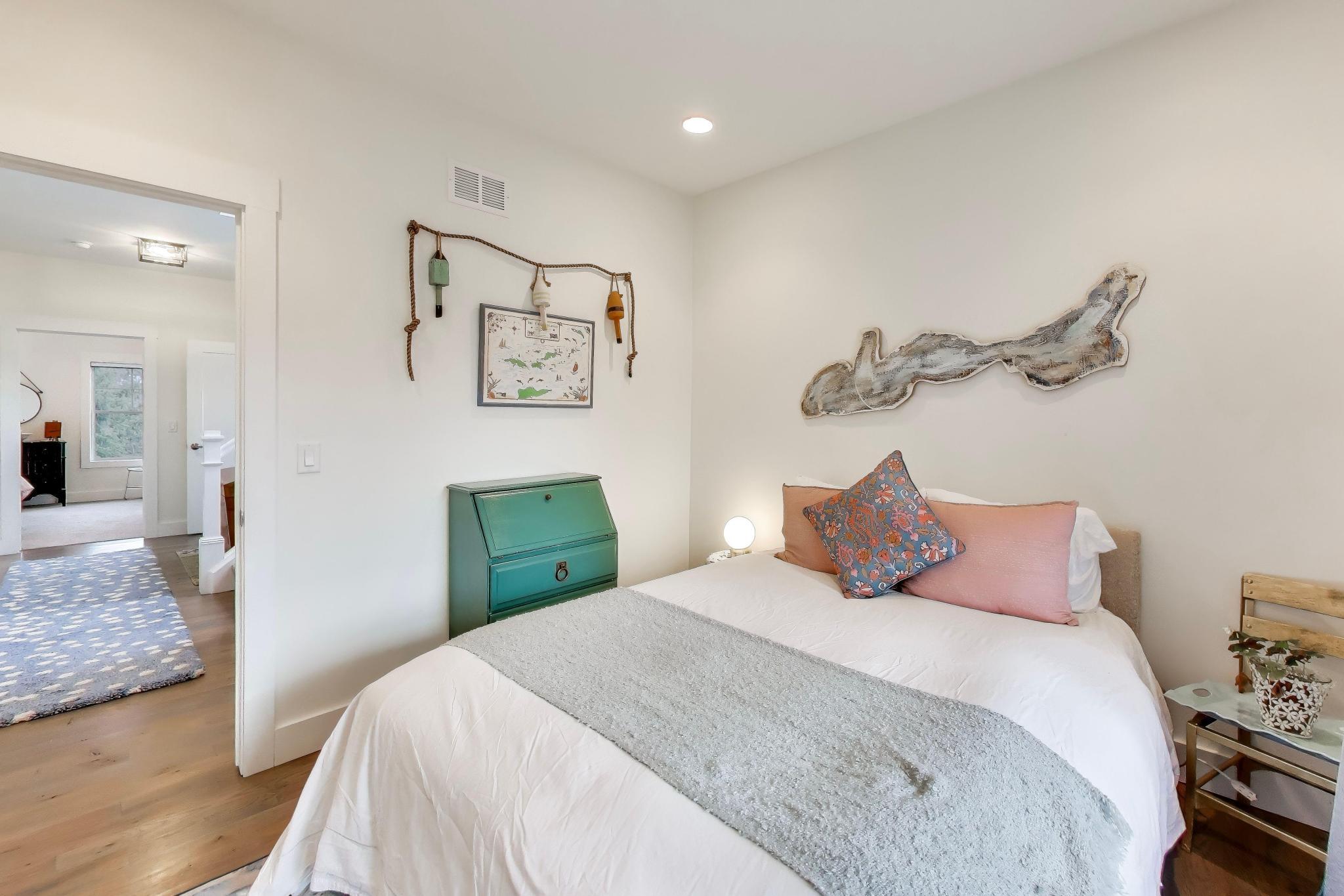 603 Agaming Road Fontana, WI 53125 - Photo 21 of 68 Cozy guest bedroom with hardwood flooring, soft neutral tones, and thoughtful decorative details for a welcoming feel.