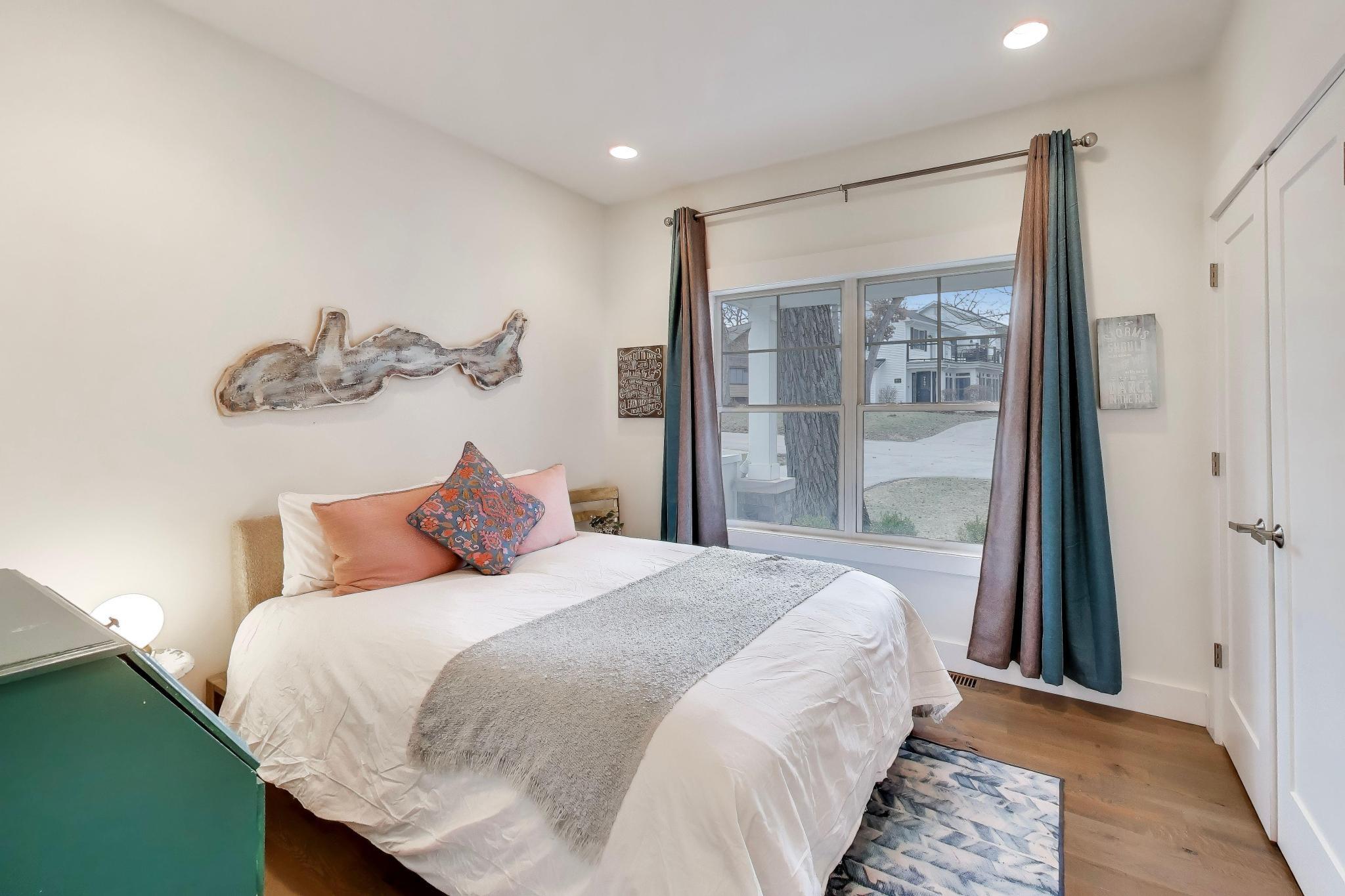 603 Agaming Road Fontana, WI 53125 - Photo 22 of 68 A bright and inviting bedroom featuring warm wood flooring, recessed lighting, and a large picture window that fills the space with natural light. This flex room would also be an office or den.