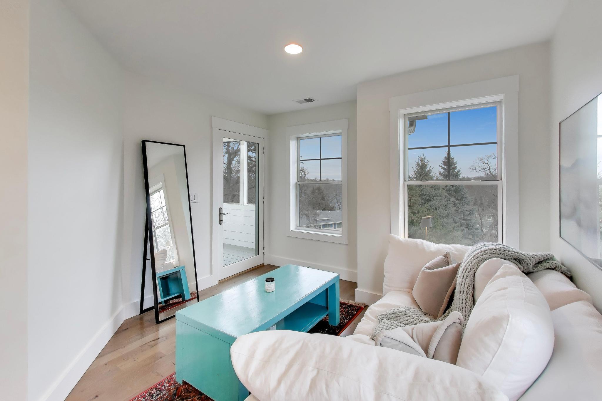603 Agaming Road Fontana, WI 53125 - Photo 29 of 68 Cozy sitting area with large windows and access to the screened porch, offering elevated views and natural light.