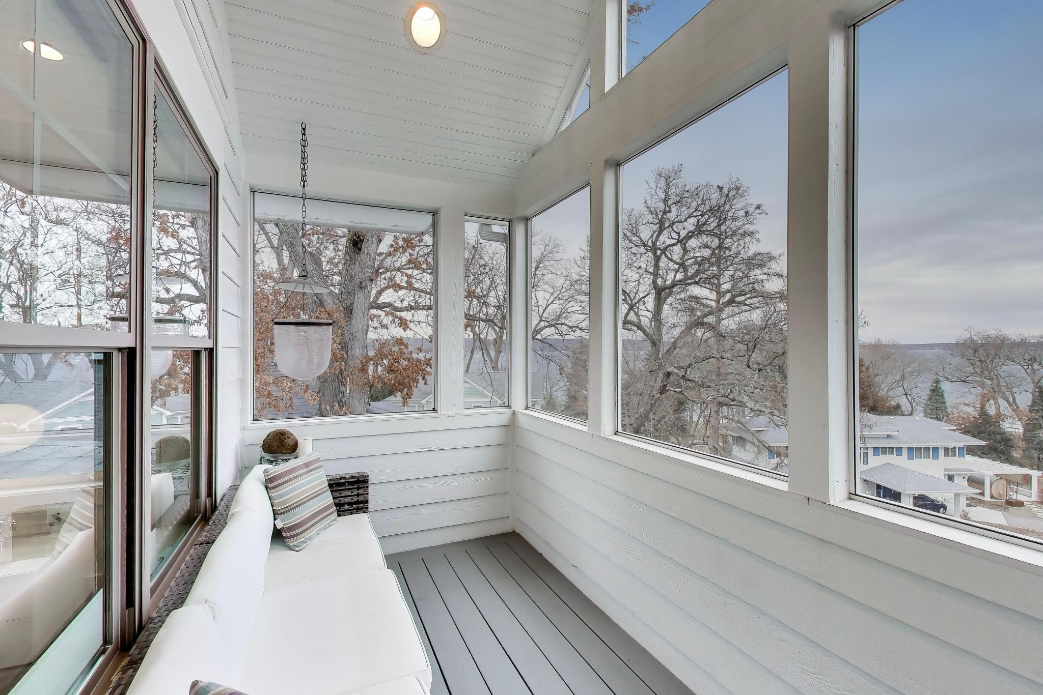 603 Agaming Road Fontana, WI 53125 - Photo 30 of 68 Inviting screened porch with composite flooring and elevated water views framed by mature trees.