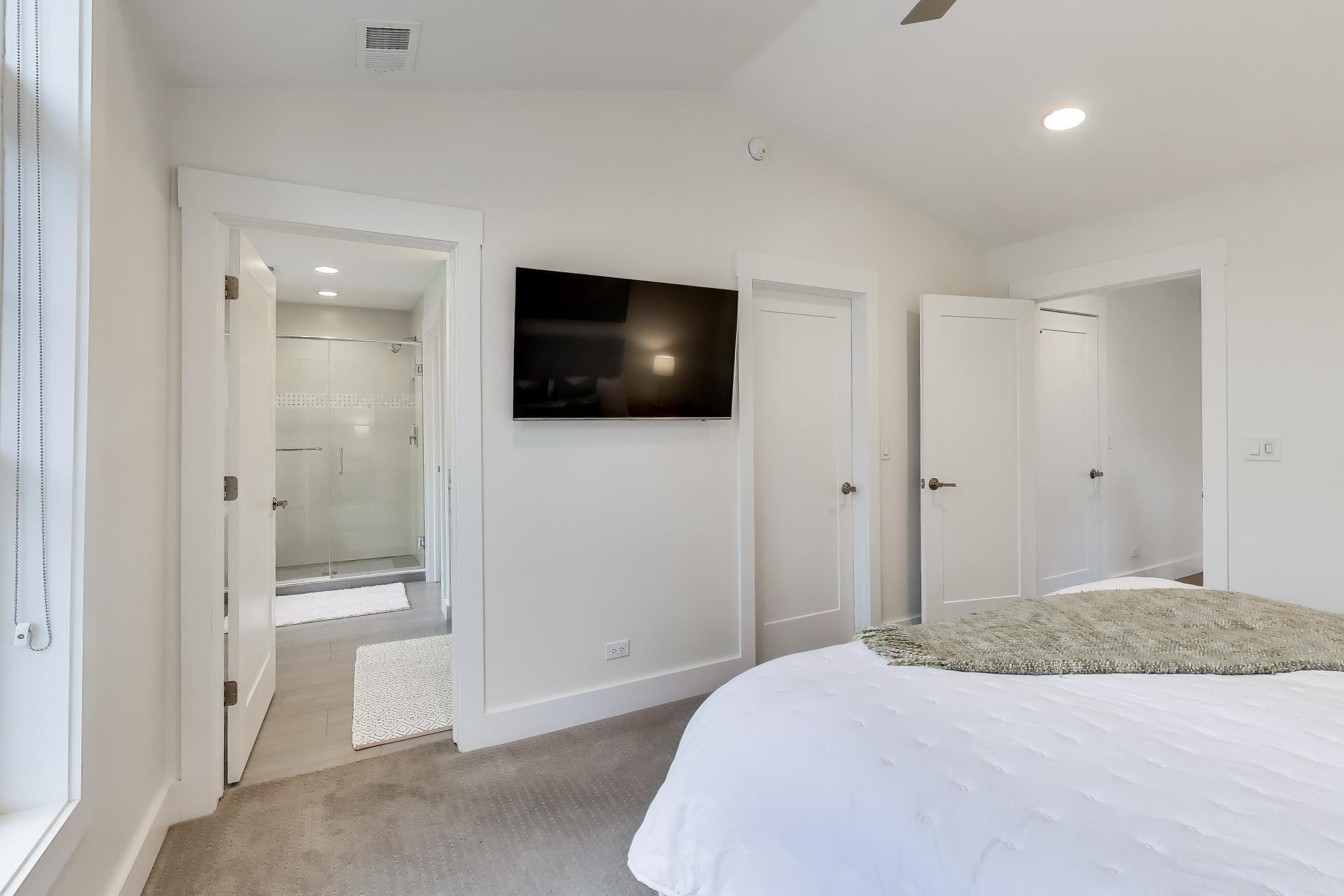 603 Agaming Road Fontana, WI 53125 - Photo 39 of 68 Spacious bedroom with plush carpeting, ceiling fan, and direct access to the en suite bath and walk-in closet.