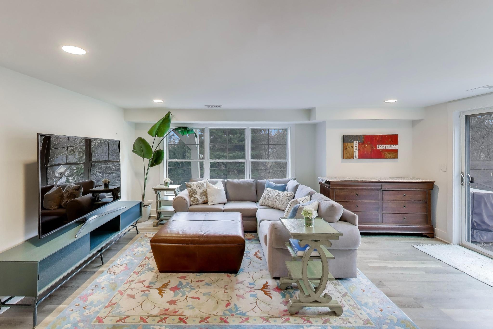 603 Agaming Road Fontana, WI 53125 - Photo 41 of 68 Comfortable lower-level living space with wide-plank flooring, large windows, and direct access to the outdoor area.
