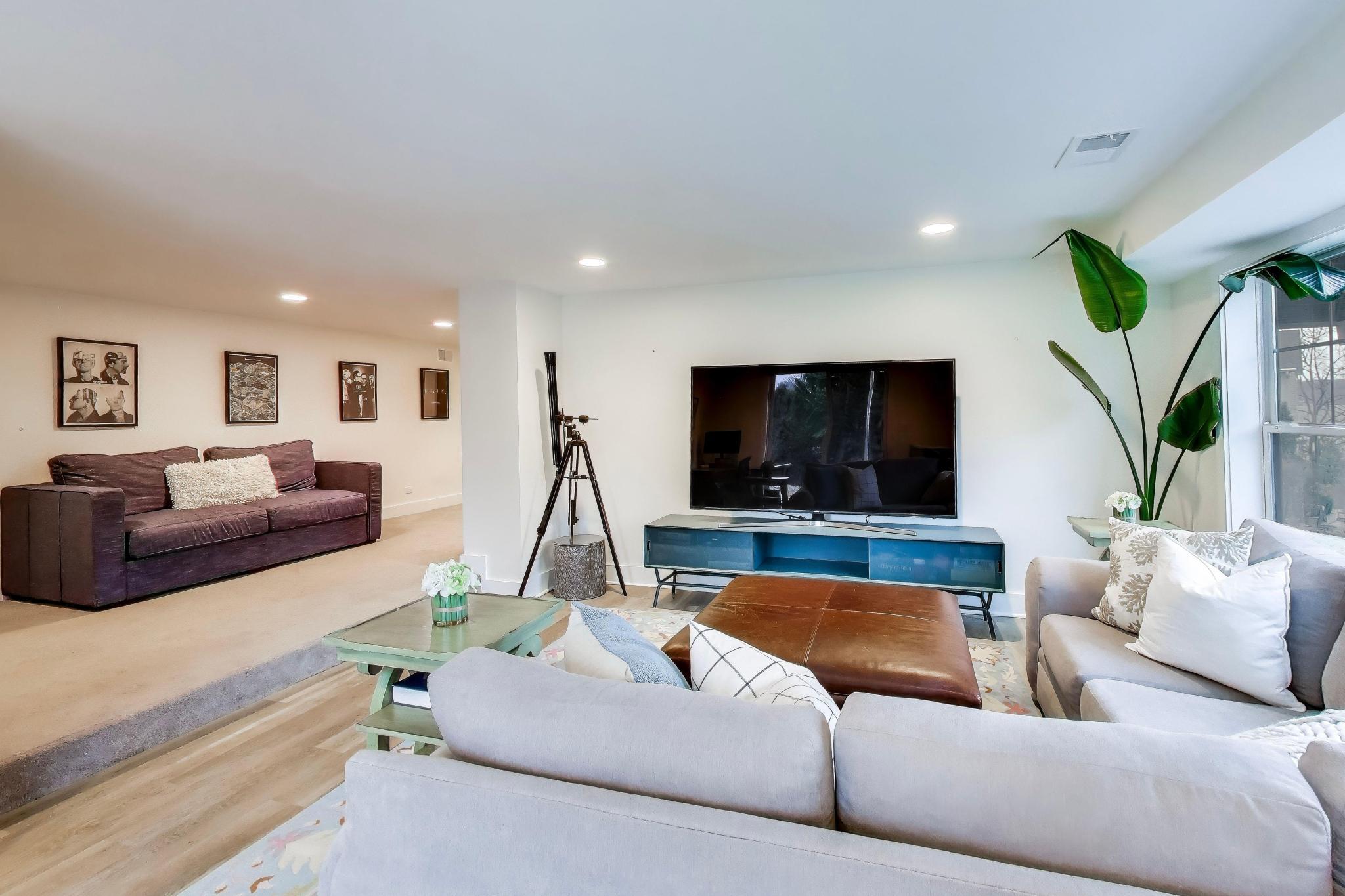 603 Agaming Road Fontana, WI 53125 - Photo 43 of 68 Comfortable lower-level living area with space for media viewing and seating, ideal for relaxing or entertaining.