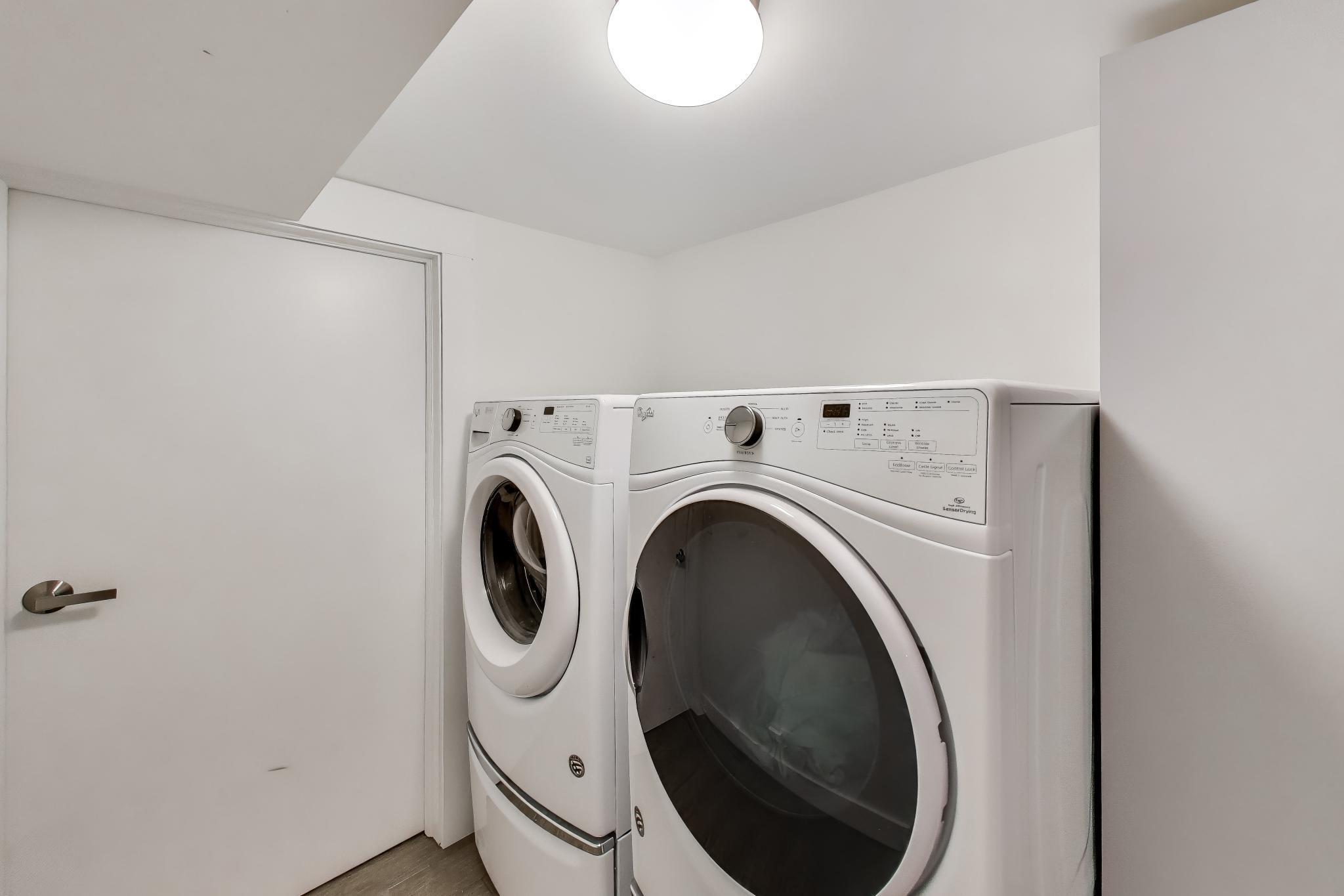 603 Agaming Road Fontana, WI 53125 - Photo 50 of 68 Convenient laundry area featuring full-size front-loading washer and dryer with overhead lighting and clean, modern finishes.