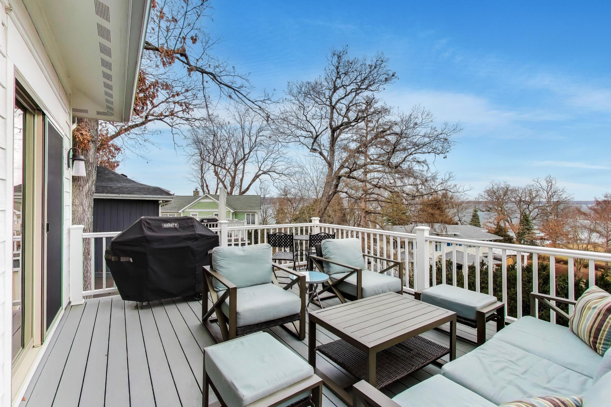603 Agaming Road Fontana, WI 53125 - Photo 4 of 68 Spacious deck with comfortable seating and a grill area, perfect for outdoor dining and entertaining. Elevated position offers scenic neighborhood and water views.