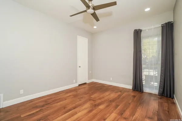 a big room with wooden floor and windows