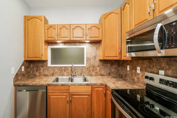 a kitchen with stainless steel appliances granite countertop a sink and cabinets