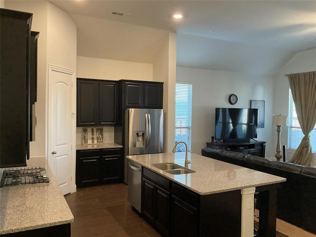 2805 Newsom Ridge Drive Mansfield, TX 76063 - Photo 12 of 33 a kitchen with a sink and a refrigerator