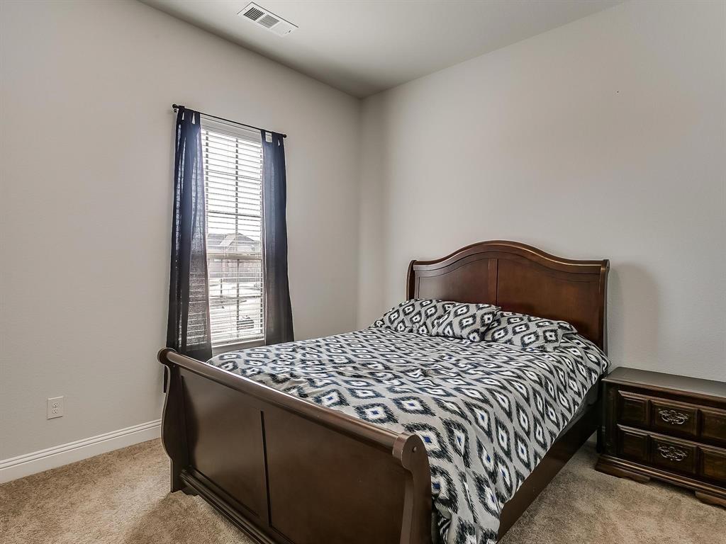 2805 Newsom Ridge Drive Mansfield, TX 76063 - Photo 17 of 33 a bedroom with a bed and window